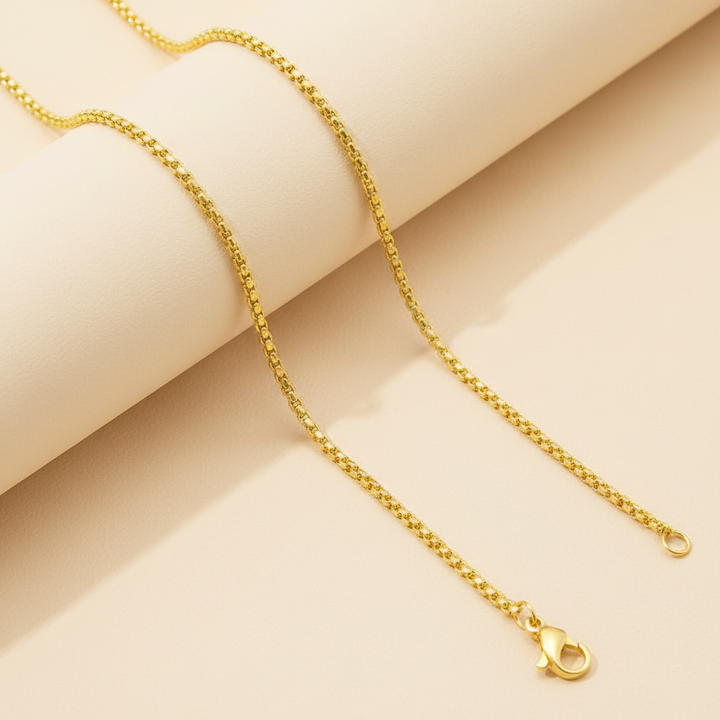 Gold Rolo Chain cream background
